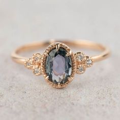 a ring with an oval blue stone surrounded by small diamonds