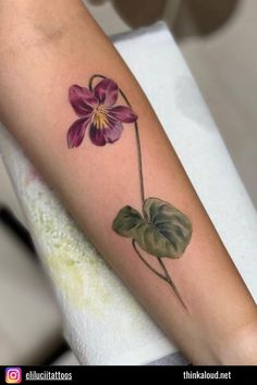 a flower with leaves on the arm