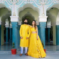 Menswear:- Faux Georgette Kurta set in yellow color. Lehenga Choli:- Readymade Faux Georgette Lehenga in Yellow,This attire with Cotton Lining is Enhanced with Fancy Tassels, Resham and Mirror Work, Available with a Faux Georgette Yellow Choli Crafted in Sleeveless and Round Neck and a Organza Dupatta in Yellow.The Choli and Lehenga Lengths are 14 and 42 inches respectively. Do Note: Accessories shown in the image are for presentation purposes only. (Slight variation in actual color vs. image is Festive Yellow Set With Resham Embroidery, Yellow Zari Work Sets For Festive Occasions, Traditional Drape Sets For Diwali, Yellow Sets With Dori Work For Reception, Yellow Dori Work Party Sets, Yellow Gown For Reception During Navratri, Festive Yellow Zari Work Sets, Festive Yellow Sets With Zari Work, Fitted Yellow Gown For Festive Occasions