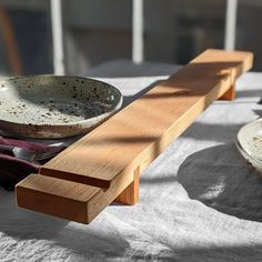 two bowls sit on top of a table with plates and napkins in front of them