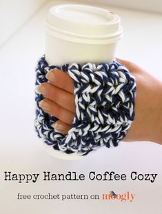 a woman's hand holding a coffee cup cozy