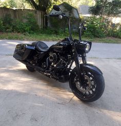 a black motorcycle is parked in the driveway