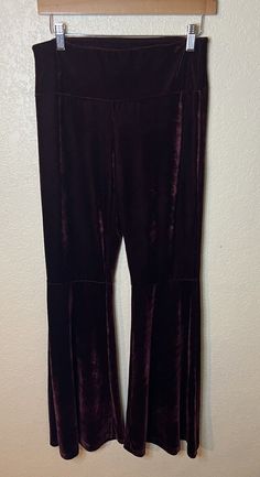 Elevate your wardrobe with these stunning purple velvet pants from Free Spirit. These pants feature a flattering flared leg style, with a comfortable and stretchy polyester and elastane material that ensures a perfect fit. The pull-on closure and flat front design make them easy to wear and pair with any outfit. Machine washable for easy care, these dress pants are perfect for any occasion. The solid pattern and vintage-free design ensure that you'll stand out from the crowd. Available in size medium, these pants are a must-have for any fashion-forward woman's wardrobe. Flared Velvet Bottoms, Fitted Velvet Wide Leg Pants, Stretch Velvet Bottoms For Fall, Fall Velvet Flare Bottoms, Stretch Velvet Flare Bottoms, Purple Wide-leg Pants For Fall, Burgundy Wide Leg Pants For Party, Stretch Velvet Full-length Bottoms, Stretch Velvet Full Length Bottoms