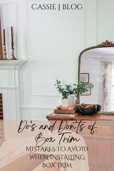 a dresser with a mirror and some books on it