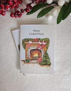 a christmas card sitting on top of a table next to some red and white decorations