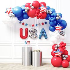 an american flag balloon arch with the letters usa and stars in red, white, and blue balloons