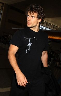 a young man is walking through an airport