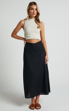 Get ready to turn heads in this flirty and playful Sundry Midi Skirt! With its linen look fabric and high-waisted design, this A-line skirt is perfect for casual days out or dressed up for a night on the town. The cross-front detail adds a touch of sassiness to your outfit, while the black color ensures versatility. Whether you pair it with a crop top or a cozy sweater, this midi skirt is sure to become your new go-to piece for effortless style. So why wait? Embrace your inner fashionista and st Summer Flared Maxi Skirt For Night Out, Flattering Midi Skirt For Summer, Chic Maxi Skirt For Vacation, Elegant Vacation Flared Skirt Bottoms, Elegant Flared Skirt Bottoms For Vacation, Fitted Linen Maxi Skirt For The Beach, Chic Flared Maxi Skirt For Vacation, Elegant Stretch Maxi Skirt For Vacation, Chic Stretch Maxi Skirt For Day Out