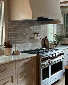 a stove top oven sitting inside of a kitchen