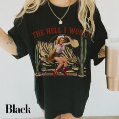 Add some vintage charm to your wardrobe with our Hell I Won't Shirt. This custom designed cowgirl shirt is perfect for any country girl who loves country music, rodeos, and western style. Crafted from high-quality materials, this Western graphic tee is built to last. To keep your shirt in top condition, simply wash it inside out in cold water and lay it flat to dry. You can also use a dryer on low heat, just remember to turn it inside out first. At The Southern Thistle, we value our customers' i Retro Graphic Print Tops For Rodeo, Retro Screen Print Tops For Rodeo, Retro Letter Print Tops For Rodeo, Vintage Relaxed Fit Tops For Rodeo, Black Graphic Print Top For Rodeo, Vintage Letter Print Tops For Rodeo, Black Short Sleeve Western Style Top, Vintage Crew Neck Top For Rodeo, Vintage Tops For Fall Country Concerts