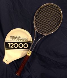 two tennis racquets are laying on a blue background with the name wilson