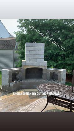 an outdoor fireplace made out of cinder blocks