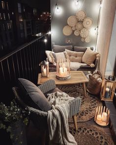 a living room filled with lots of furniture and candles on top of a wooden table