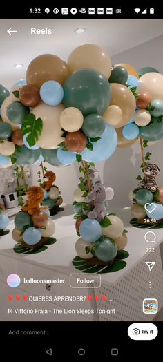 balloons floating in the air with animals and leaves on them, as well as other decorations