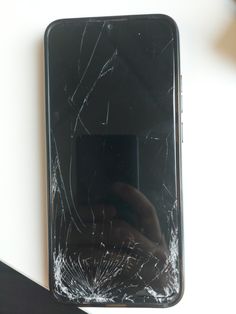 a broken cell phone sitting on top of a table