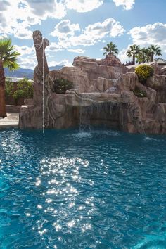 a large pool with a waterfall in the middle