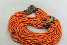 "A vintage Naga Konyak multi strand bead necklace made in Nagaland in the first half of the 20th century. In good condition - one strand has missing focal bead and was tied off a long time ago - can be seen in the photos. Includes an old silver coin made into a button, for a button and loop closure. 28\" long 15 strands 15x7mm center bead" Unique Multi-strand Polished Beads, Unique Multi-strand Hand-strung Beads, Vintage Multi-strand Colorful Beaded Necklaces, Vintage Multi-strand Beaded Necklaces With Colorful Beads, Vintage Multi-strand Beaded Necklace With Colorful Beads, Traditional Multi-strand Polished Beads, Vintage Multi-strand Beaded Necklace With Polished Beads, Traditional Multi-strand Beads For Jewelry Making, Traditional Hand-strung Multi-strand Beads