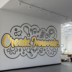 a large white wall with the words create innovate painted on it