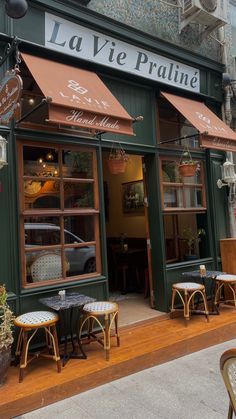 the outside of a restaurant with tables and chairs