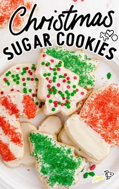 christmas sugar cookies on a plate with sprinkles and red, green and white frosting