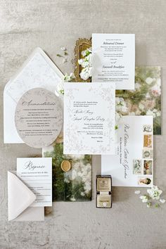 the wedding stationery is laid out on top of each other