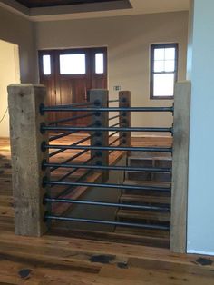 the inside of a building with wooden floors and metal railings on each side of the door