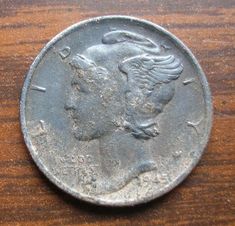 an old coin sitting on top of a wooden table