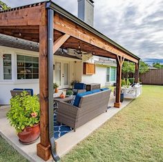 an outdoor living area with patio furniture and potted plants