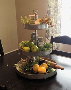 two tiered trays filled with fruit on top of a table