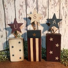 three wooden blocks with stars on them and the letters u, s, and a usa