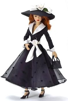 a doll wearing a black dress and hat