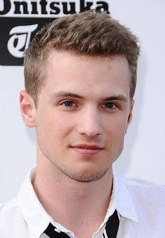 a young man wearing a white shirt and black tie