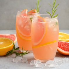 three glasses filled with drinks and garnished with raspberries