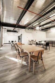 an empty conference room with wooden tables and chairs