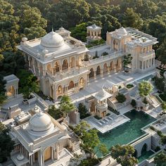 an aerial view of a large white building surrounded by trees