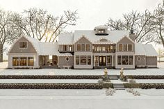 a large house with lots of windows and snow on the ground