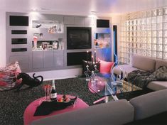 a living room filled with lots of furniture next to a wall covered in glass blocks