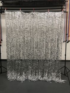 an image of a curtain made out of tinsel and plastic foil on a tripod