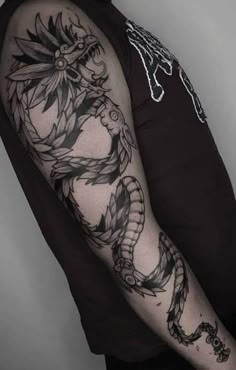 a man with a dragon tattoo on his arm