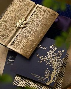 an open book sitting on top of a table next to other books and paper goods