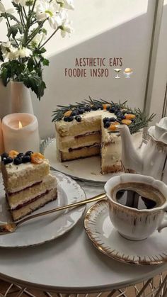 two slices of cake on plates next to a cup and saucer with a teapot