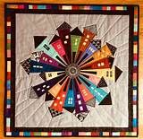 a multicolored quilt on a wooden table