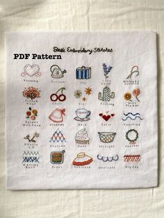 a white towel with embroidered designs on it and the words pddf written in different languages