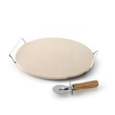 a pizza stone and spatula on a white background