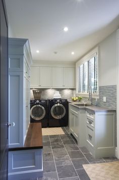 a laundry room with two washers in it