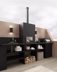 an outdoor kitchen with black cabinets and wood