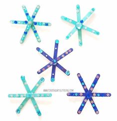 four popsicle snowflakes made with blue and green sticks