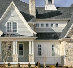 a house with white trim and gray shingles