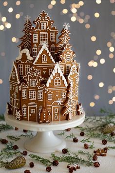 there is a cake that has been decorated with gingerbread and icing on it