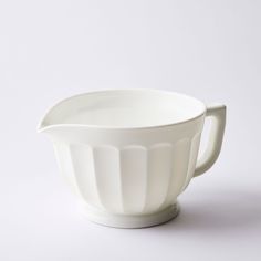 a large white bowl on a white surface